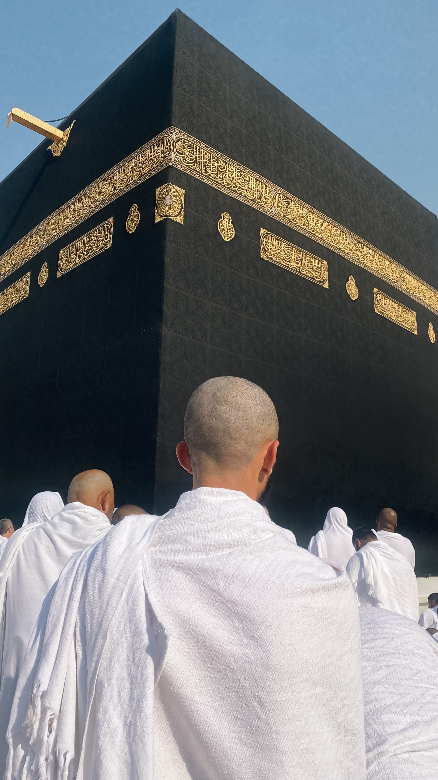 Rear View Of Muslim With Shaved Head Standing Before The Holy Kaaba